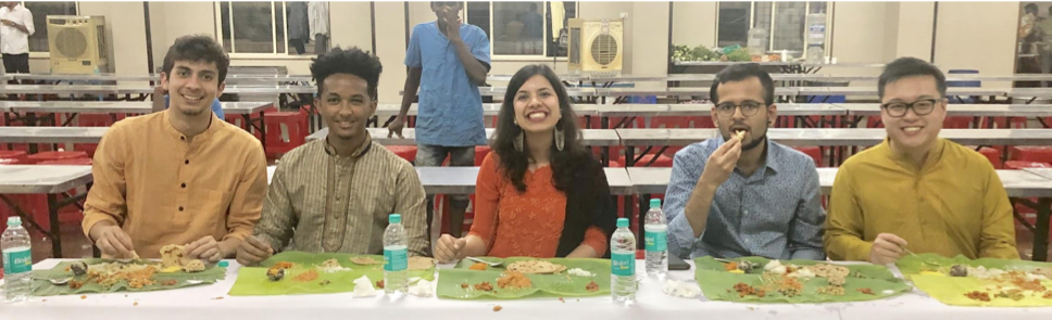 Photo of people eating and smiling for the camera