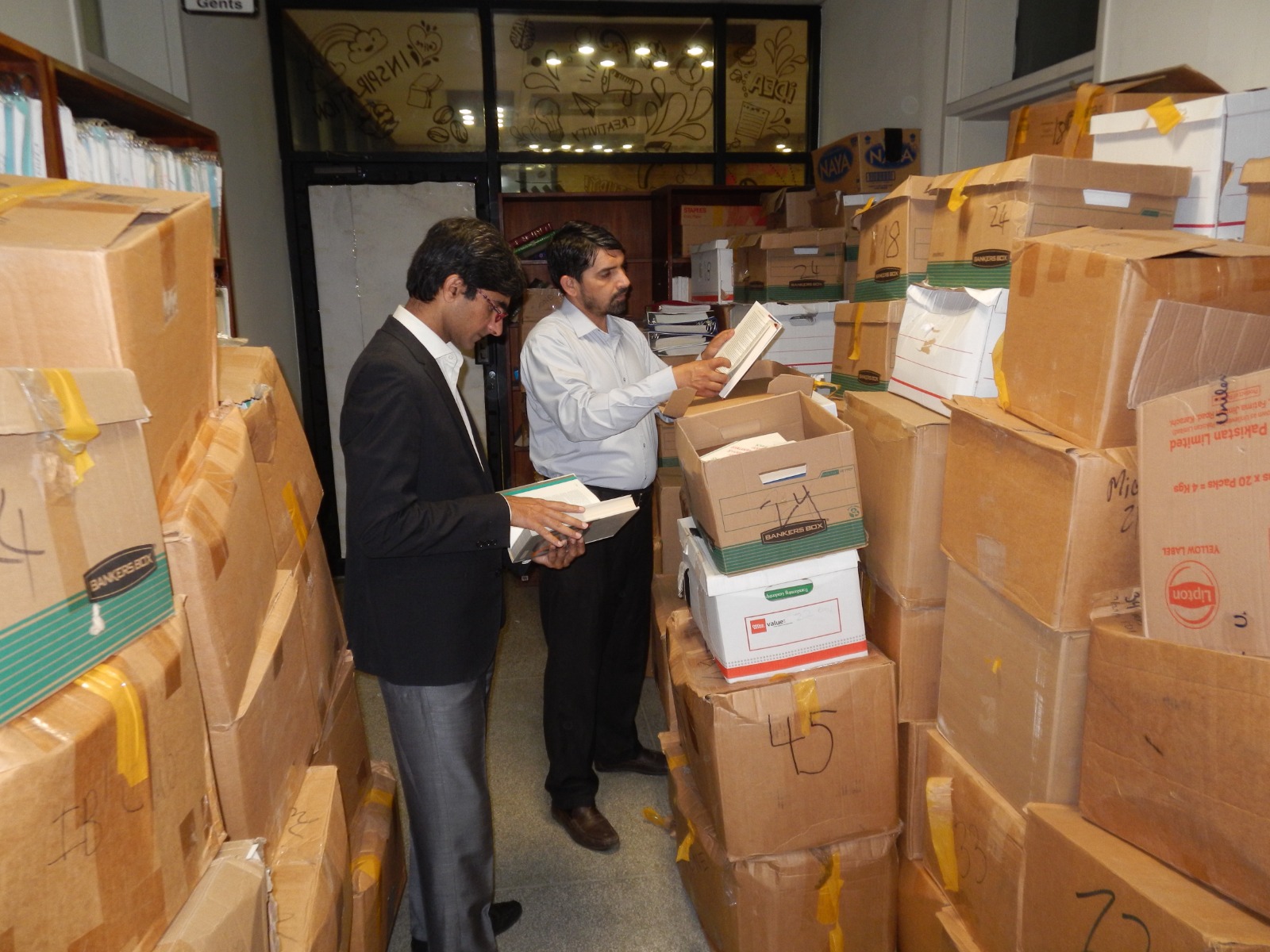 Faculty at Lahore University School of Business inspecting the boxes