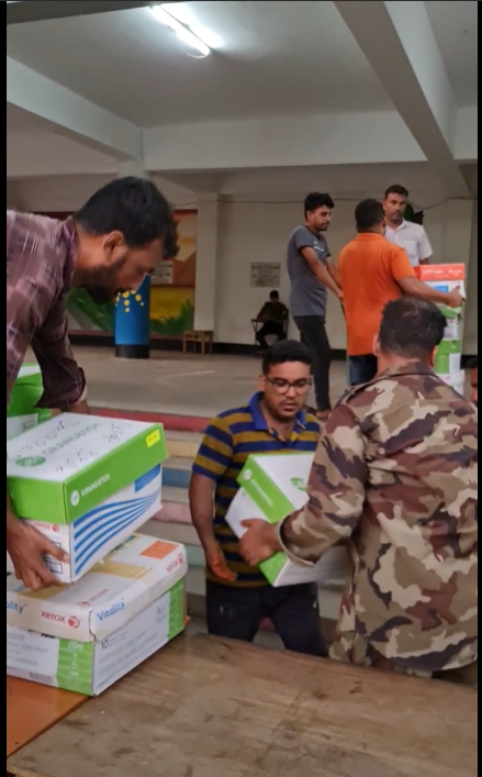 Teamwork. They are getting the books off the truck and onto the trolleys