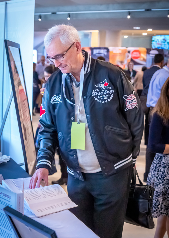 AGM attendee reviewing George Athanassakos' new book