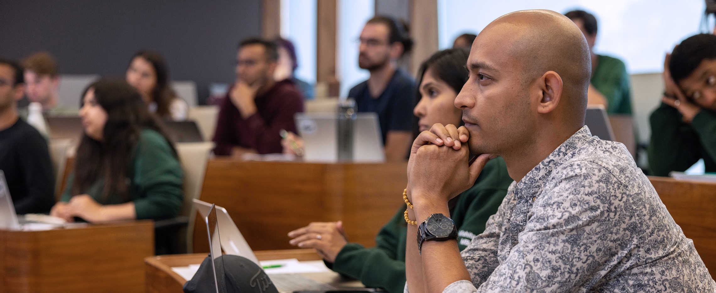 MBA students sitting in class facing the whiteboard.